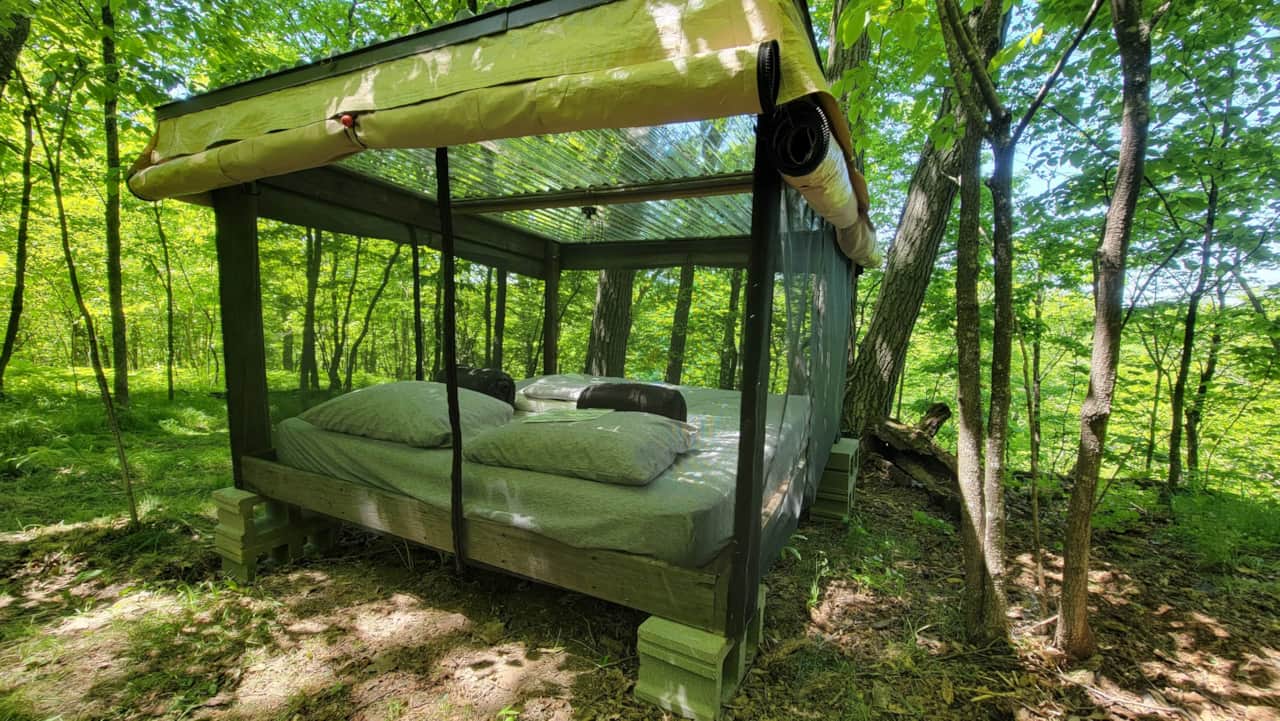King outdoor bed with screens and zip up tarp enclosure