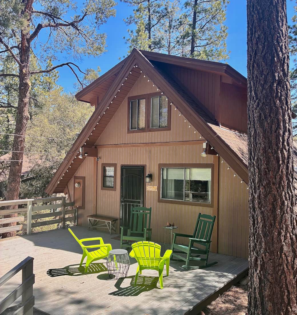 Front porch has two rocking chairs and a bench next to door for removing shoes.