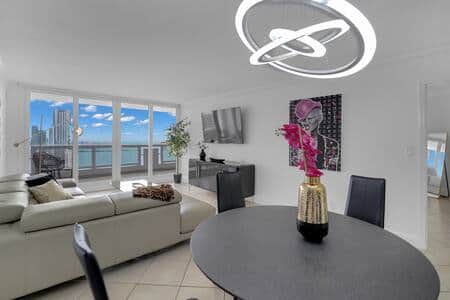 Dining area with seating for 4, living area with 65" Roku streaming tv, balcony access
