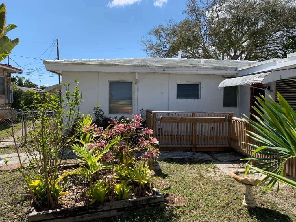 Before renovation courtyard at Casa Citron showing the main house and original entrance to Unit 3