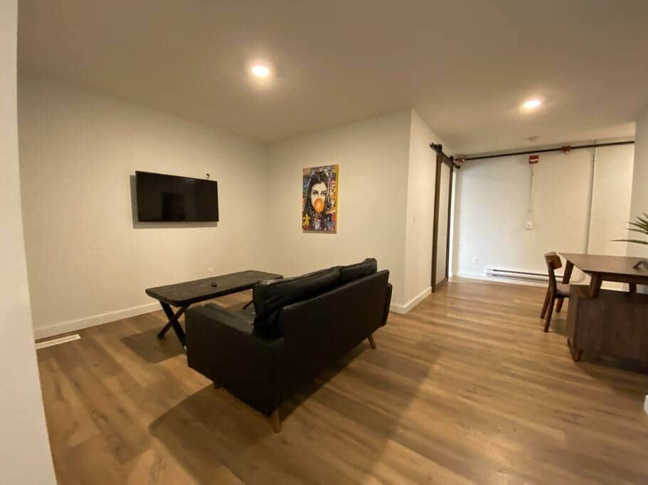 living room with smart tv and work space with couch living room with smart tv and work space with couch