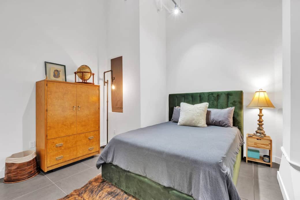 Spacious bedroom with a cozy bed and TV, perfect for relaxing anytime.