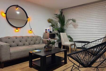 Living Room: Stylish shared space with plenty of seating and modern decor to relax or socialize.