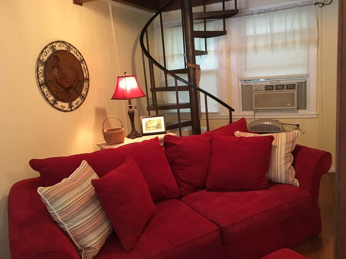 Spiral stairs leads to upper level where you will find the second bedroom with a twin bed and a playroom with a futon for sleeping.