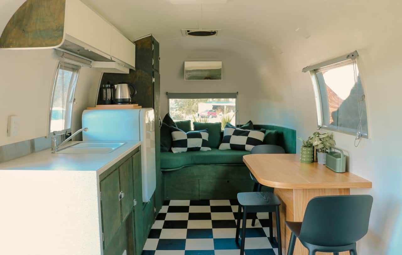 Spacious caravan with day bed, table and mini kitchen