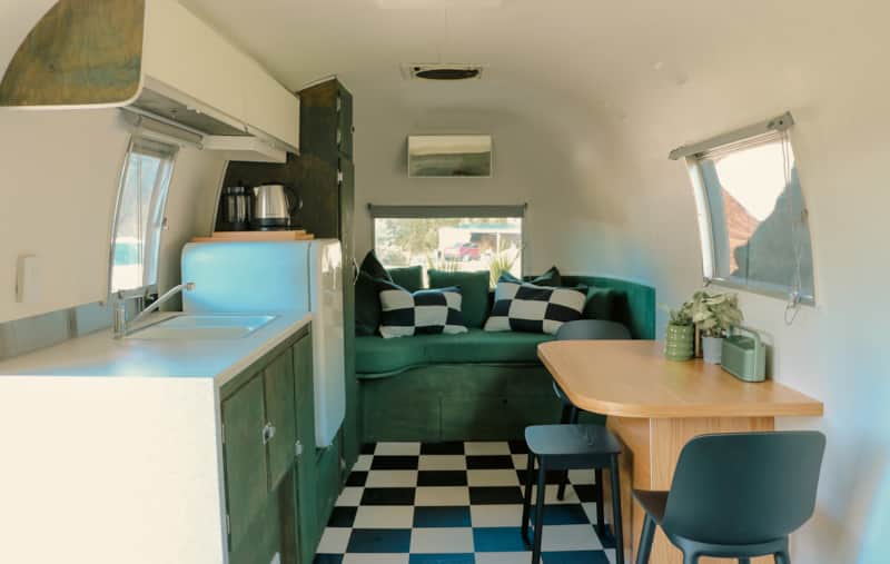 Spacious caravan with day bed, table and mini kitchen