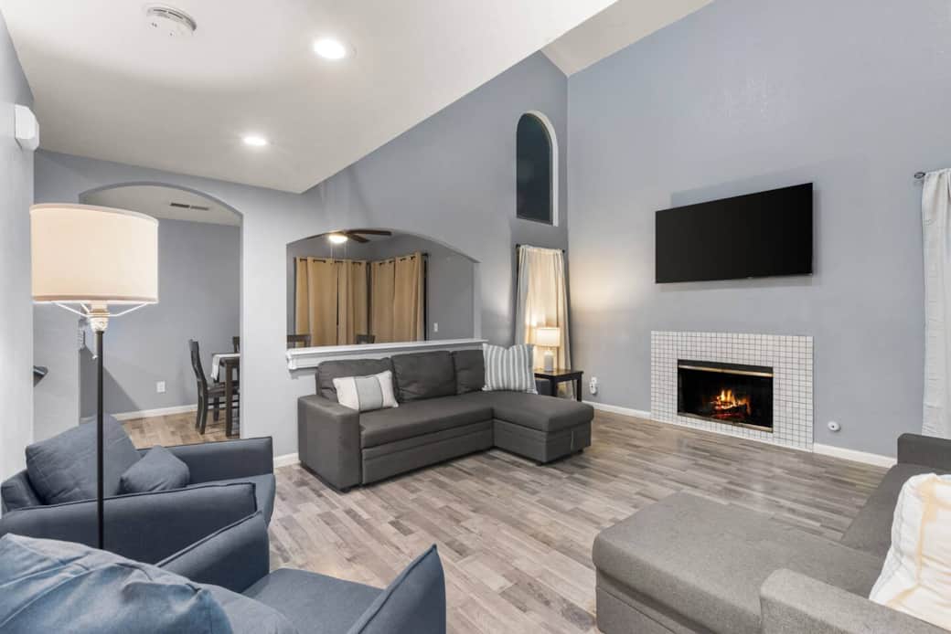 Gather around the cozy fireplace in a vaulted living room—perfect for movie nights or lounging.