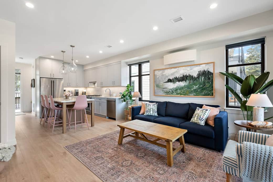 Open concept living area with original oil paintings