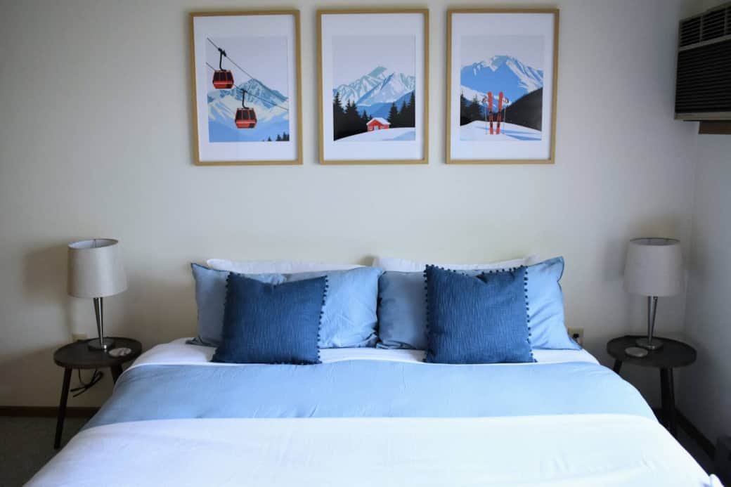 Master bedroom with a king size bed and air conditioner unit