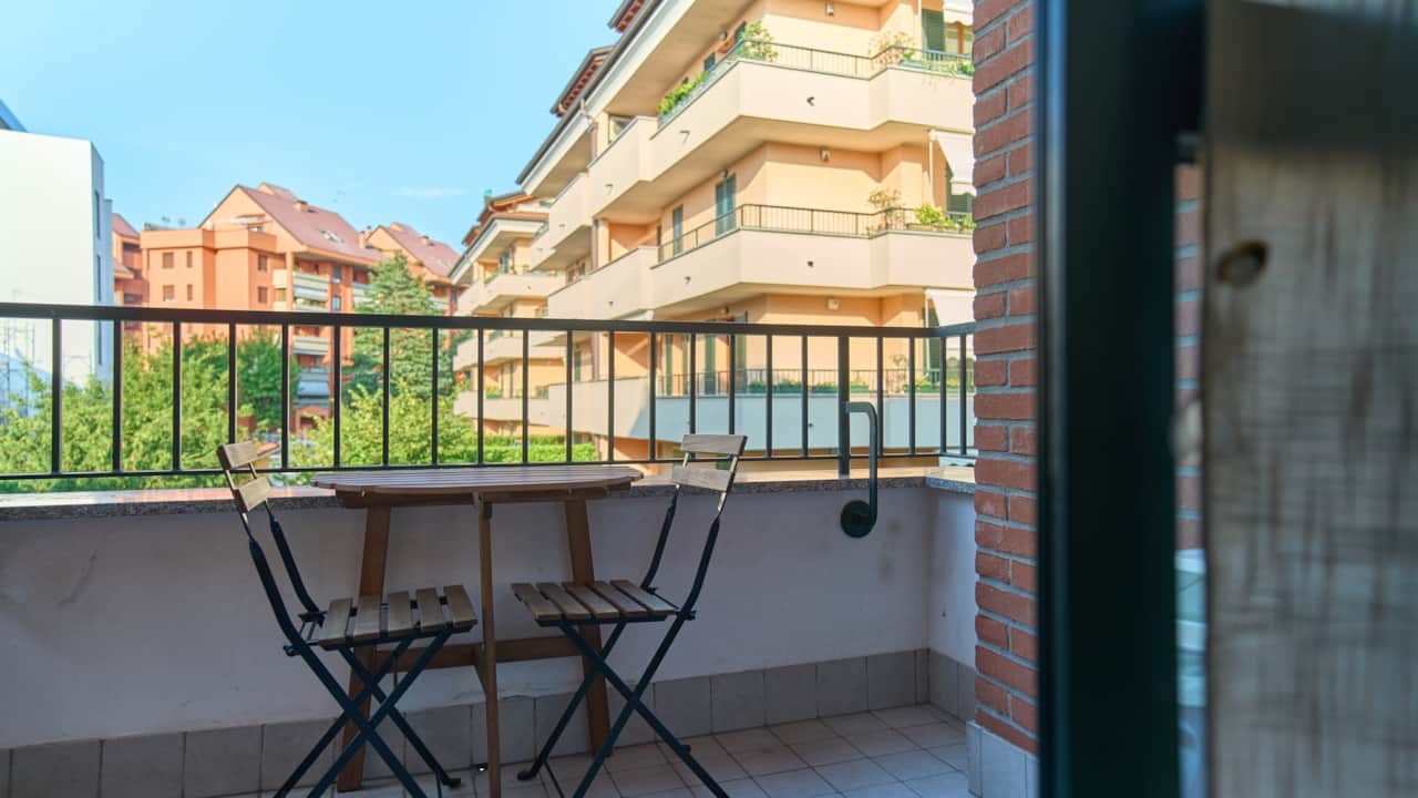 Balcony with folding chairs and railing, in Monza