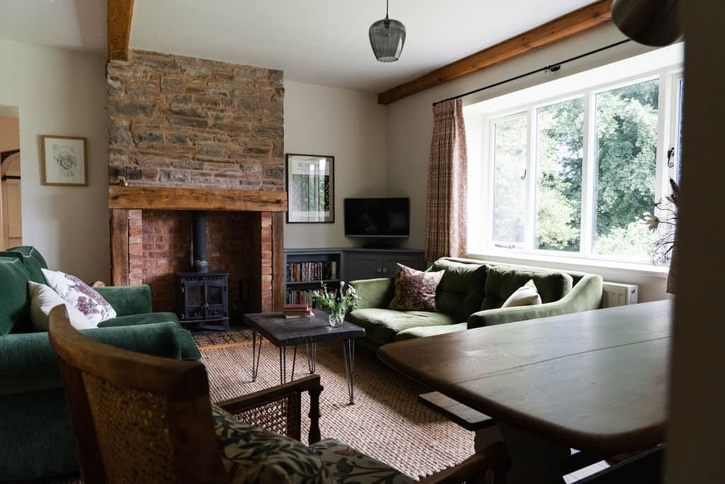 The open plan sitting and dining area with woodburning stove The open plan sitting and dining area with woodburning stove
