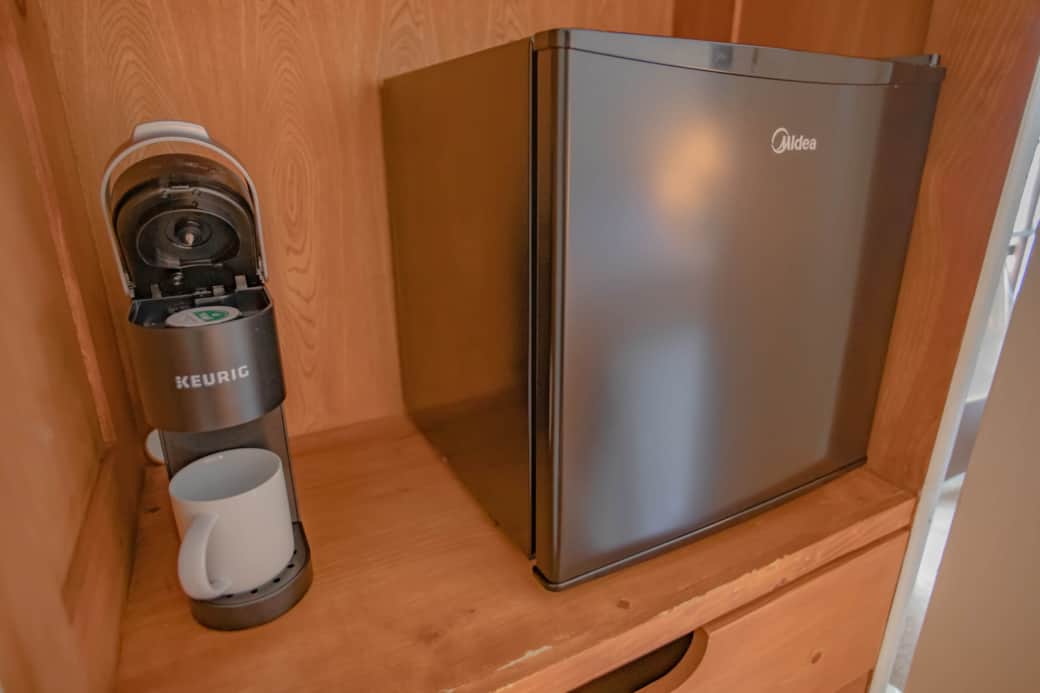 Coffee maker and mini fridge. Coffee maker and mini fridge.