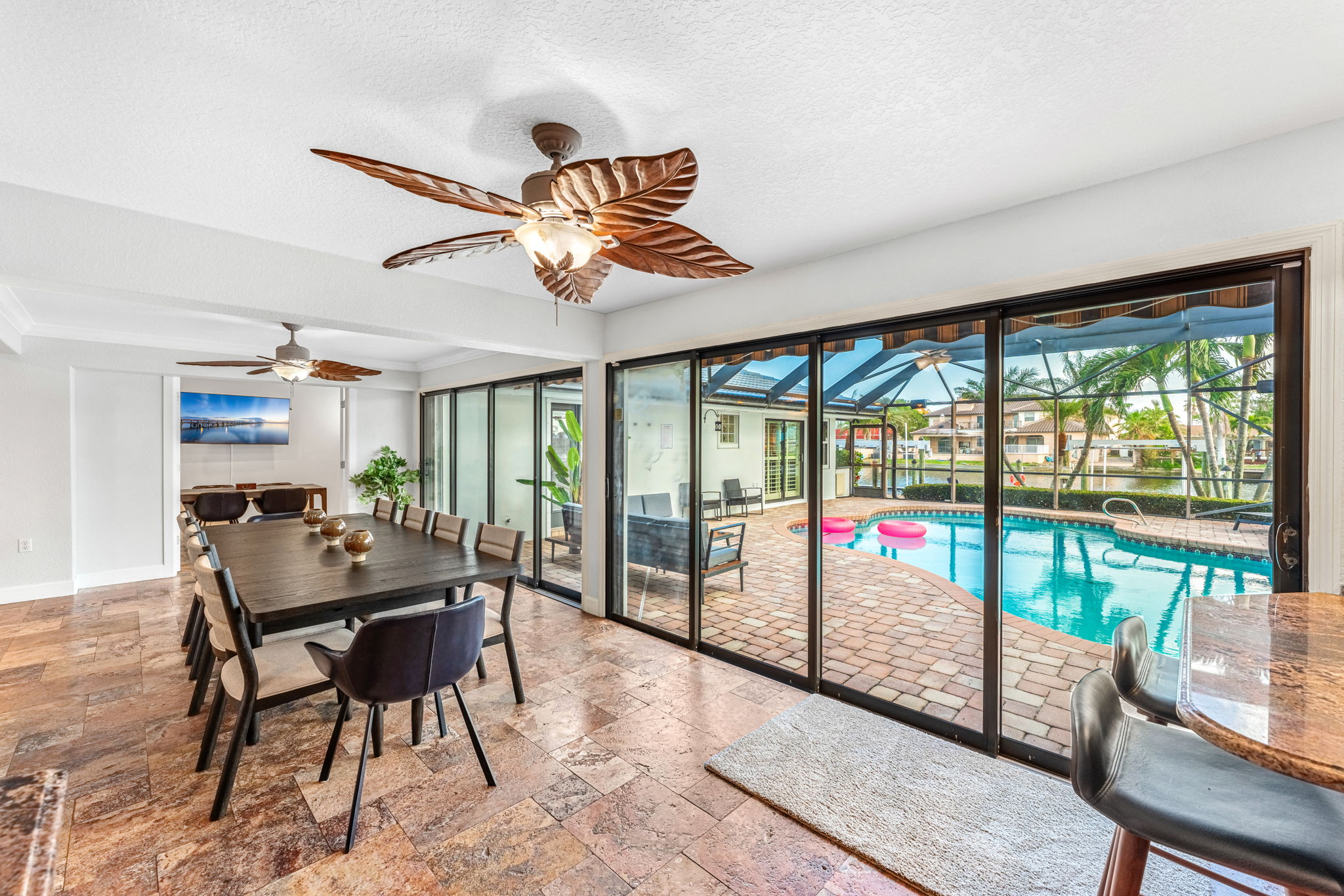 Relax in the spacious living area with panoramic views of the pool and outdoor space.