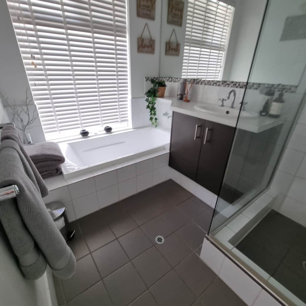 Amaroo - Bathroom with a shower and full size bath