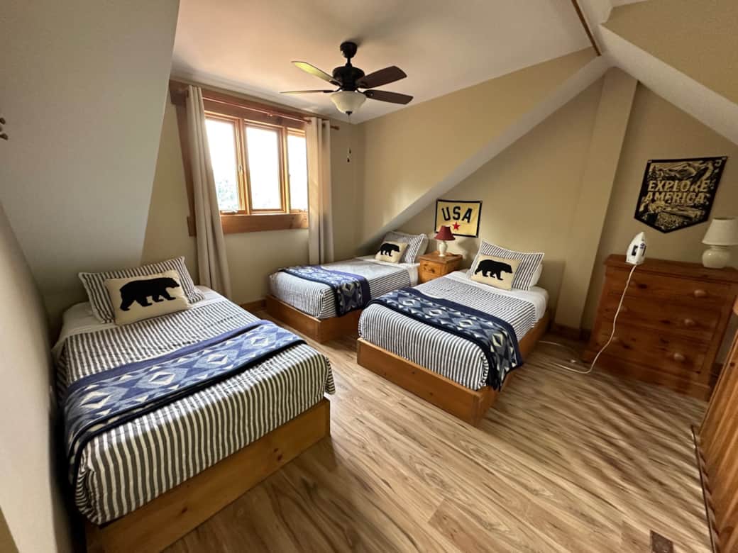 Upstairs loft area with new flooring and 3 twin beds Upstairs loft area with new flooring and 3 twin beds