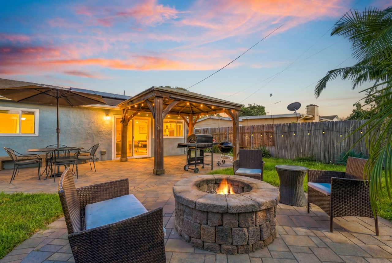 Inviting Outdoor Lounge With A Fire Pit At Dusk