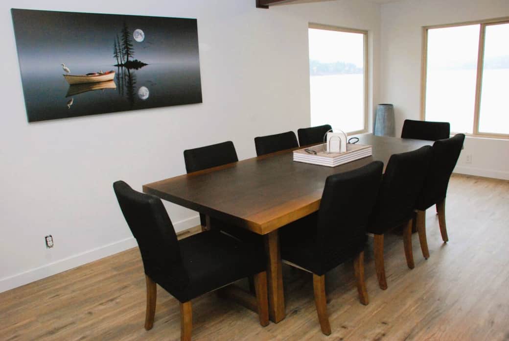 The main table seats 8 with an additional folding table and chairs located in the basement. Covered outdoor dining spaces are also available in the front and the lakeside of the house.