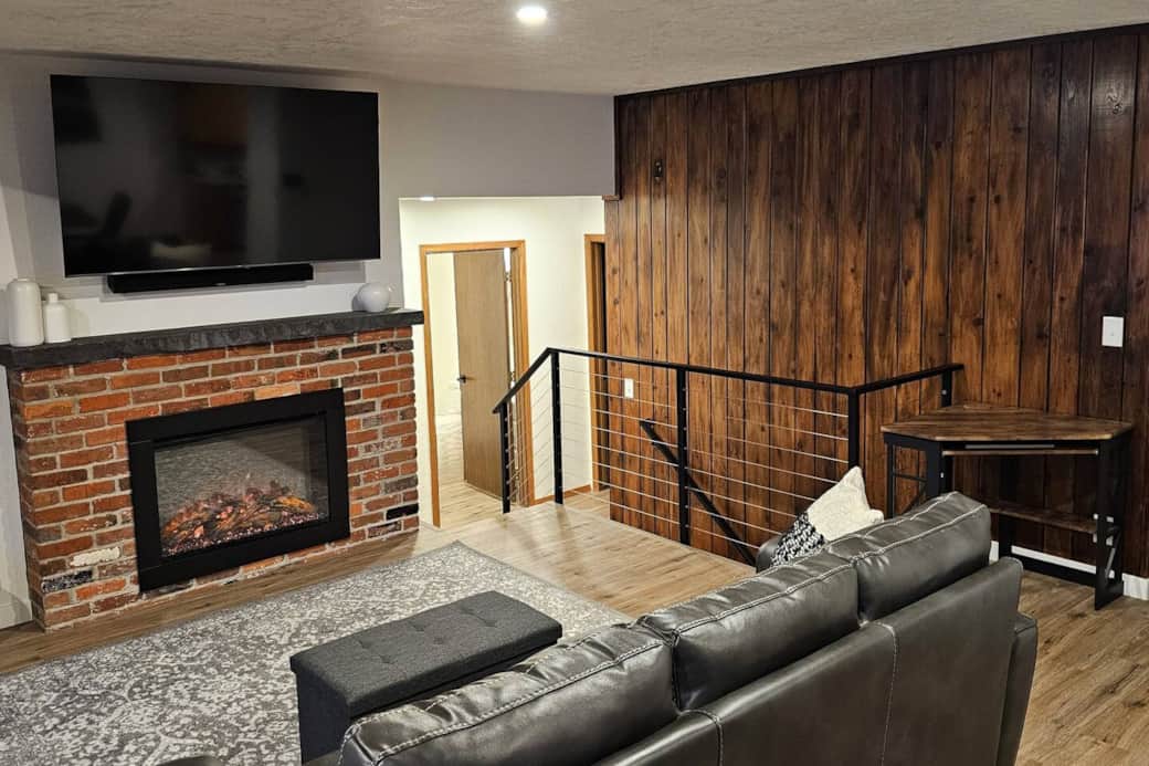 Living room, desk, and steps to bedrooms/basement