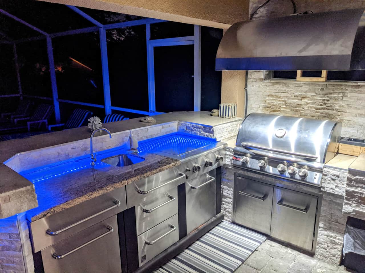 A state of art grill with a wet washing station as well as an outdoor refrigerator.