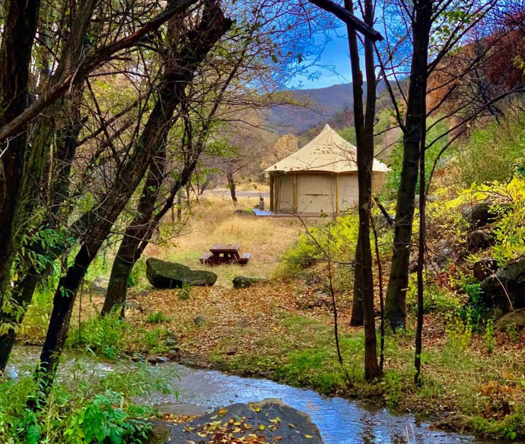 The Howard Creek camp tent. one of two camping areas with a tent available to rent. The other area  is known as the Fish camp tent and is identical on the outside in size and shape, with furnishings that differ in style but not quality.