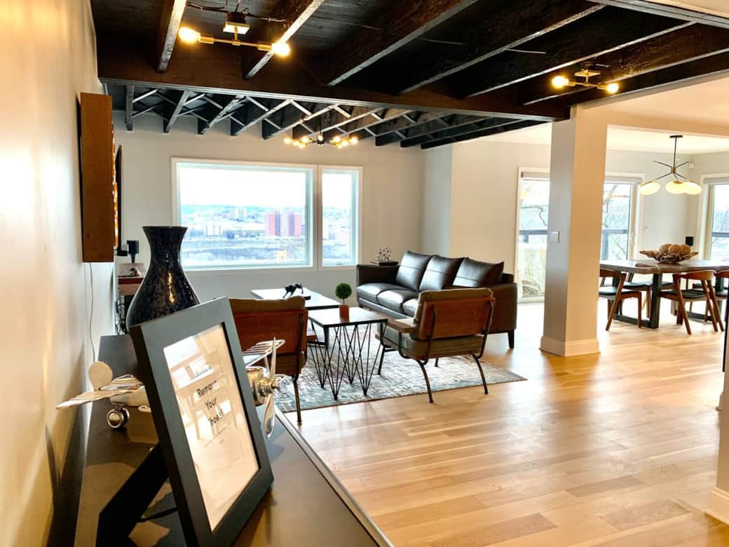 Open living/dining/ kitchen with picture windows and a dining deck!

Mid century modern living room with city views, 100+ year old exposed beams, "PGH", and 70" Samsung smart TV / sound bar w/ subwoofer.