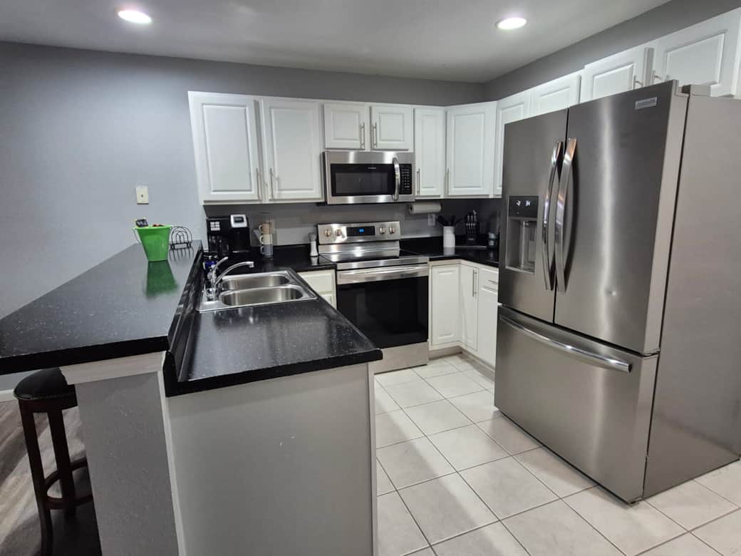 Fully stocked kitchen with modern appliances—everything you need for home-cooked meals Fully stocked kitchen with modern appliances—everything you need for home-cooked meals