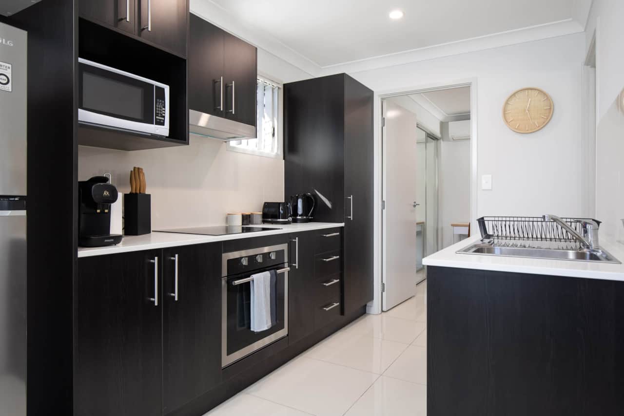 Kitchen: Sleek kitchen with ample storage, modern appliances 