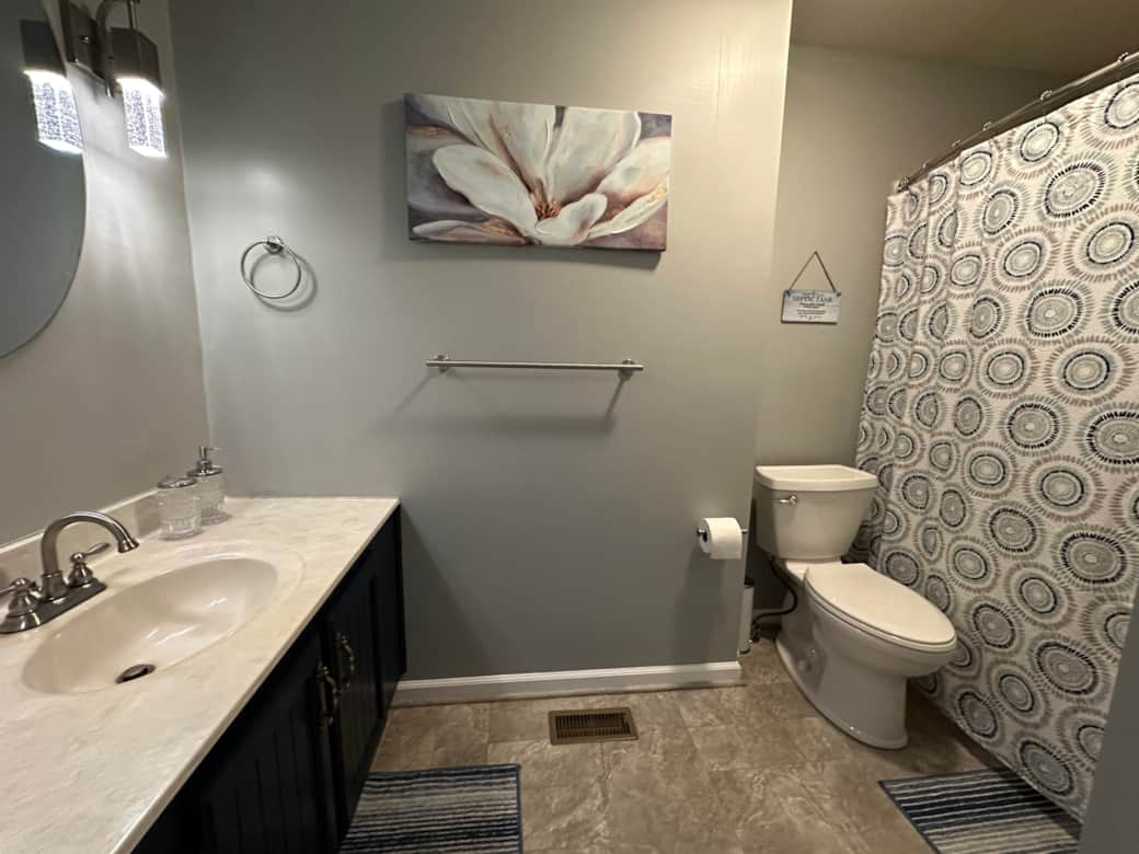 Guest bathroom with a tub/shower combo unit. Guest bathroom with a tub/shower combo unit.
