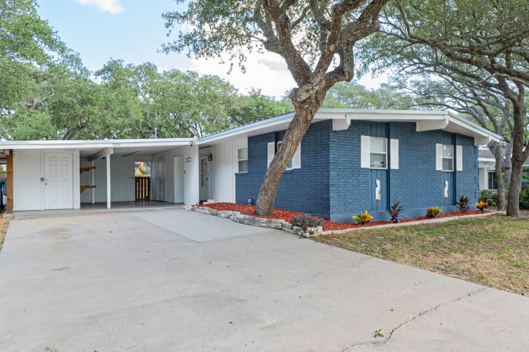 Adorable Residential Exterior. Driveway and street have plenty of room to park a boat!