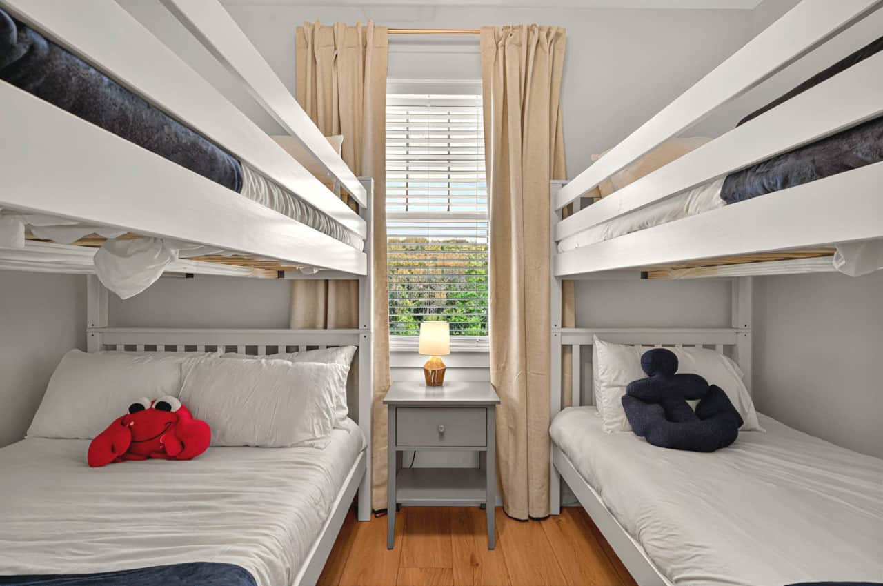 Bunk room  with one Full/Full and one Twin/Twin bunk bed, blackout curtains & pack n play in closet.