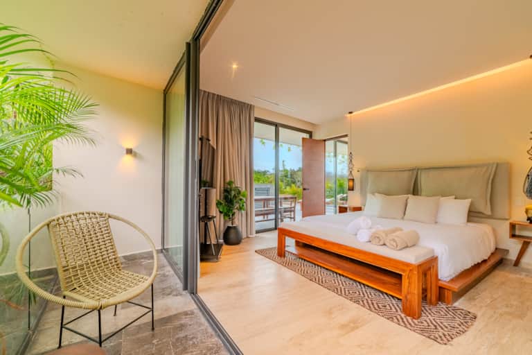 ISARA Tulum king-size bedroom with warm lighting