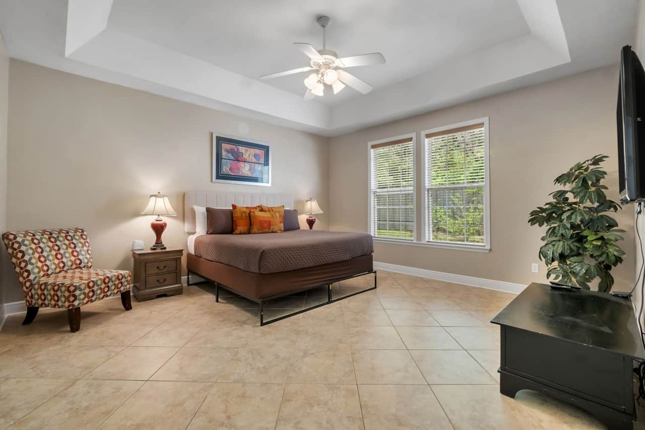 Primary bedroom with king bed and TV