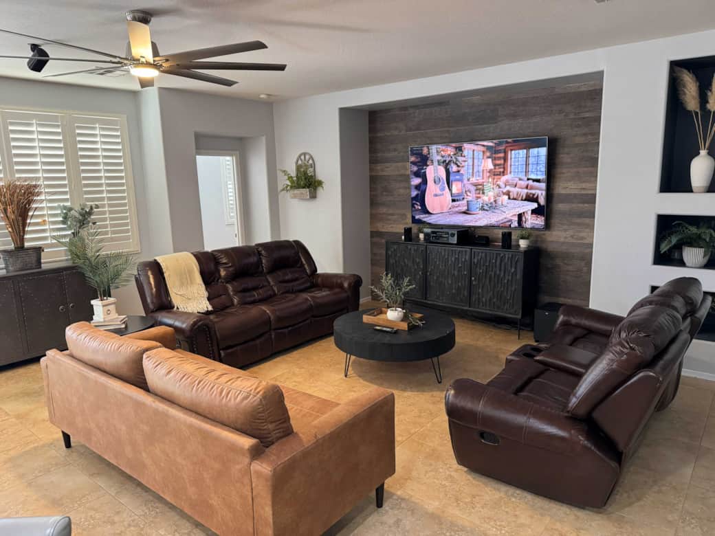 Living room with 75" TV, Denon Surround Sound, Bluetooth, PS4, and DirecTV