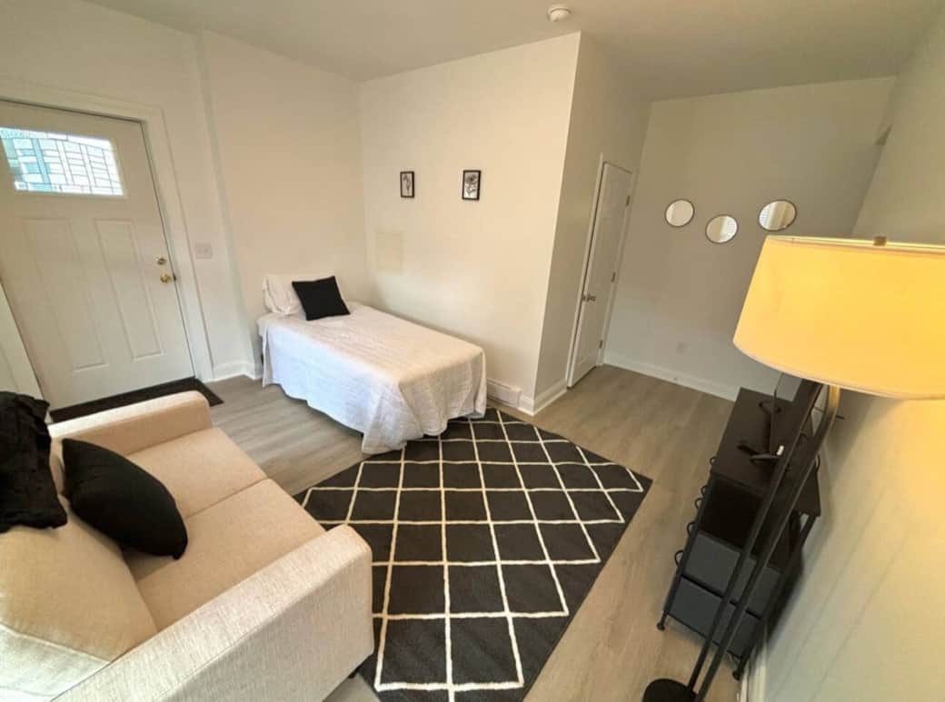 The living area features a comfortable love seat and bed for peaceful rest. 