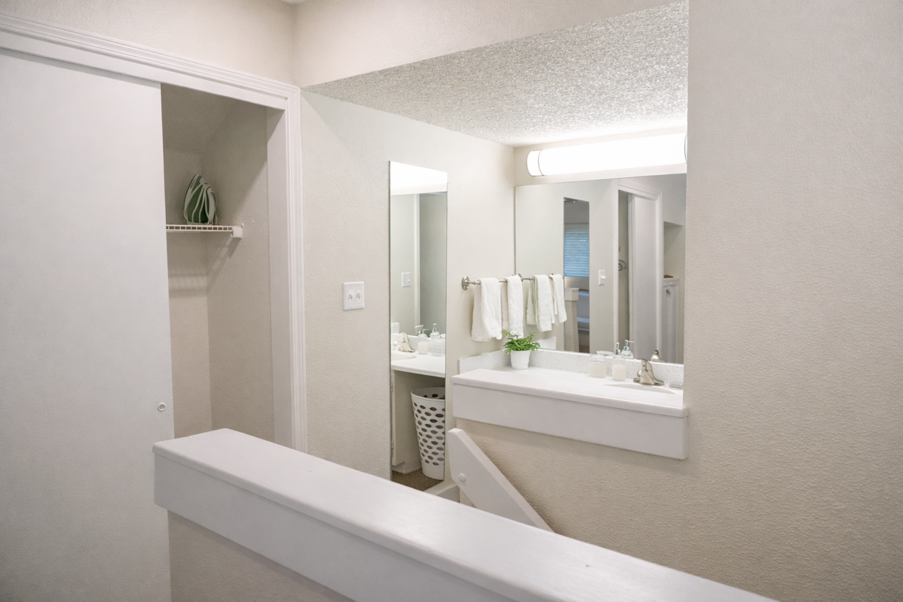 (Upstairs Bathroom) Bright, minimalist bathroom featuring a  tub and all the essentials 