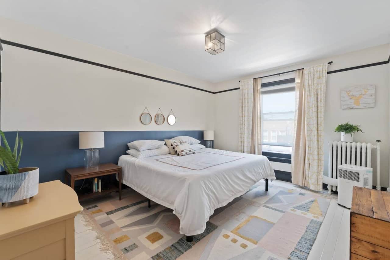 Inviting bedroom with soft natural light, cozy bedding, and tasteful modern accents.