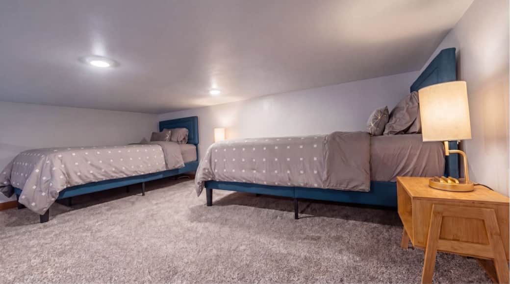 Sleeping loft with two twin beds and premium linens in the Black Hills, SD.