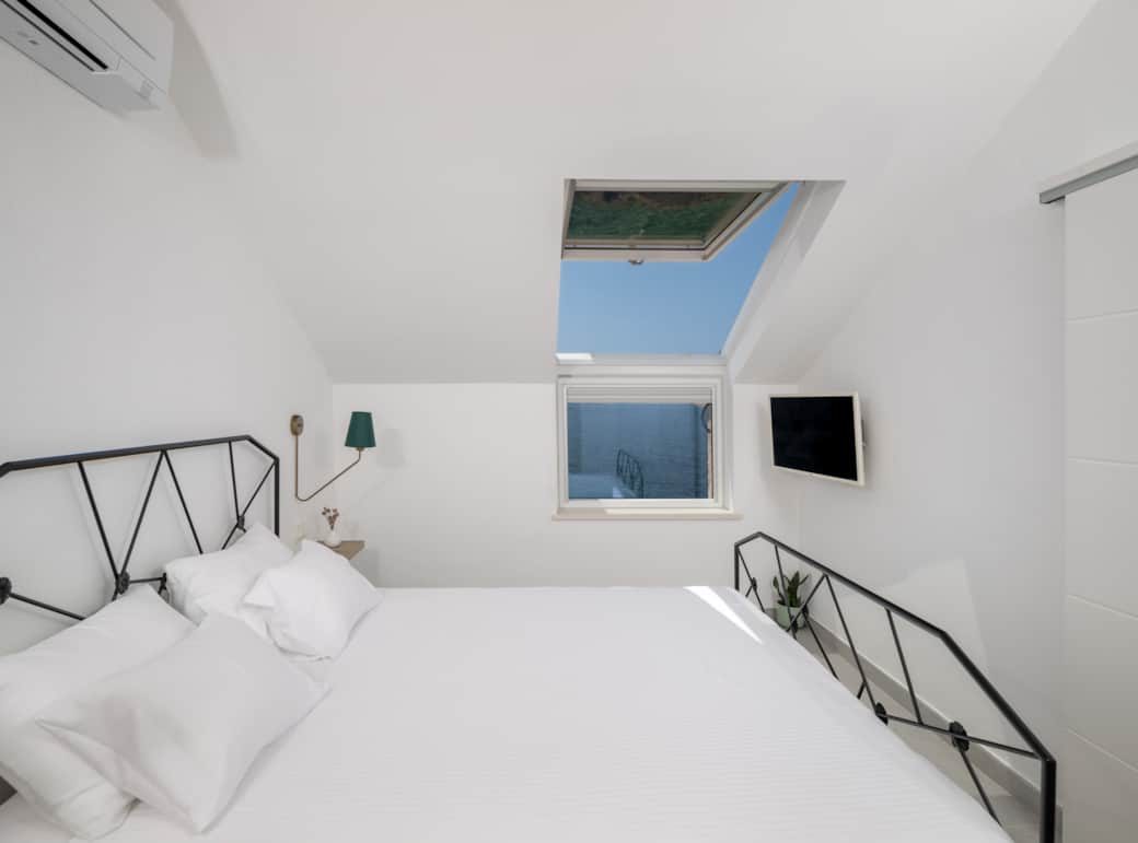 Cool comfort & sea views. East Bedroom with AC, TV, & a sunny skylight. Your Hvar retreat. Cool comfort & sea views. East Bedroom with AC, TV, & a sunny skylight. Your Hvar retreat.