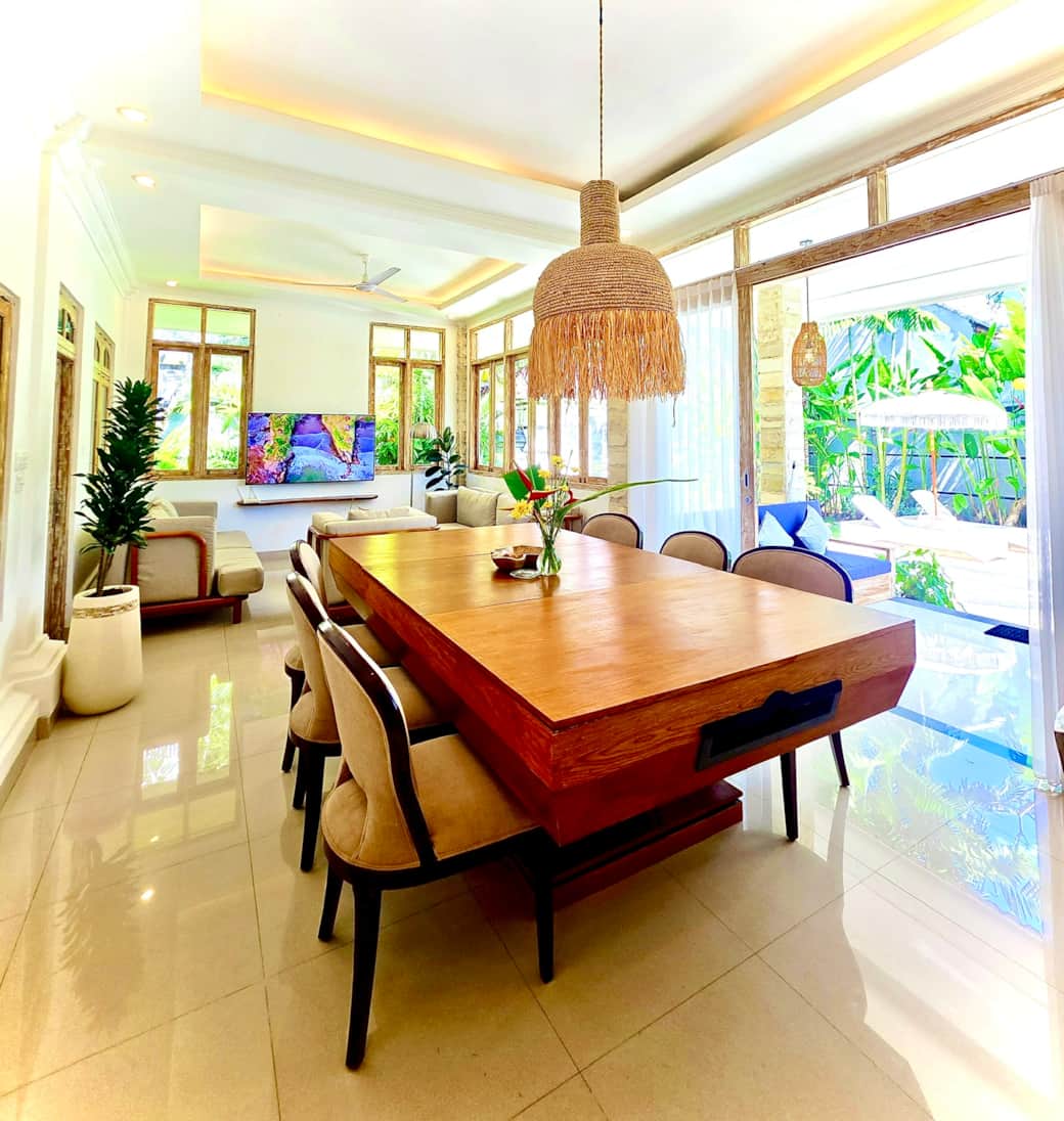 Stylish dining area with pool views and natural Bali-inspired décorStylish dining area with pool vie