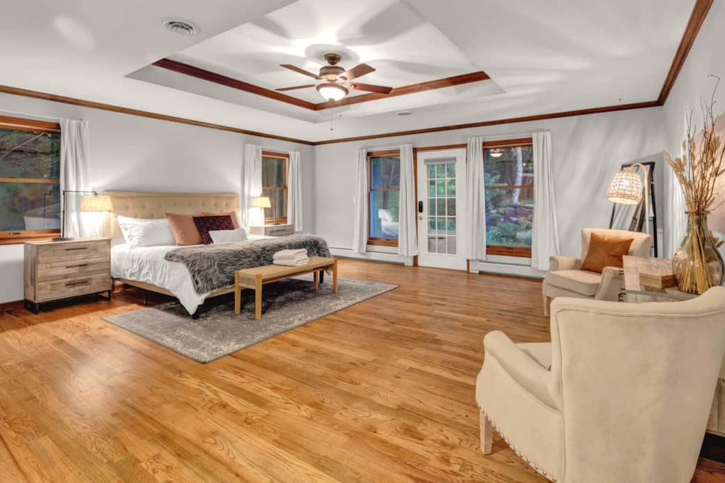Unwind in the serene master bedroom featuring a plush king bed, soft lighting, and elegant decor. A peaceful retreat designed for rest and relaxation after a day of adventure or quiet moments at home.