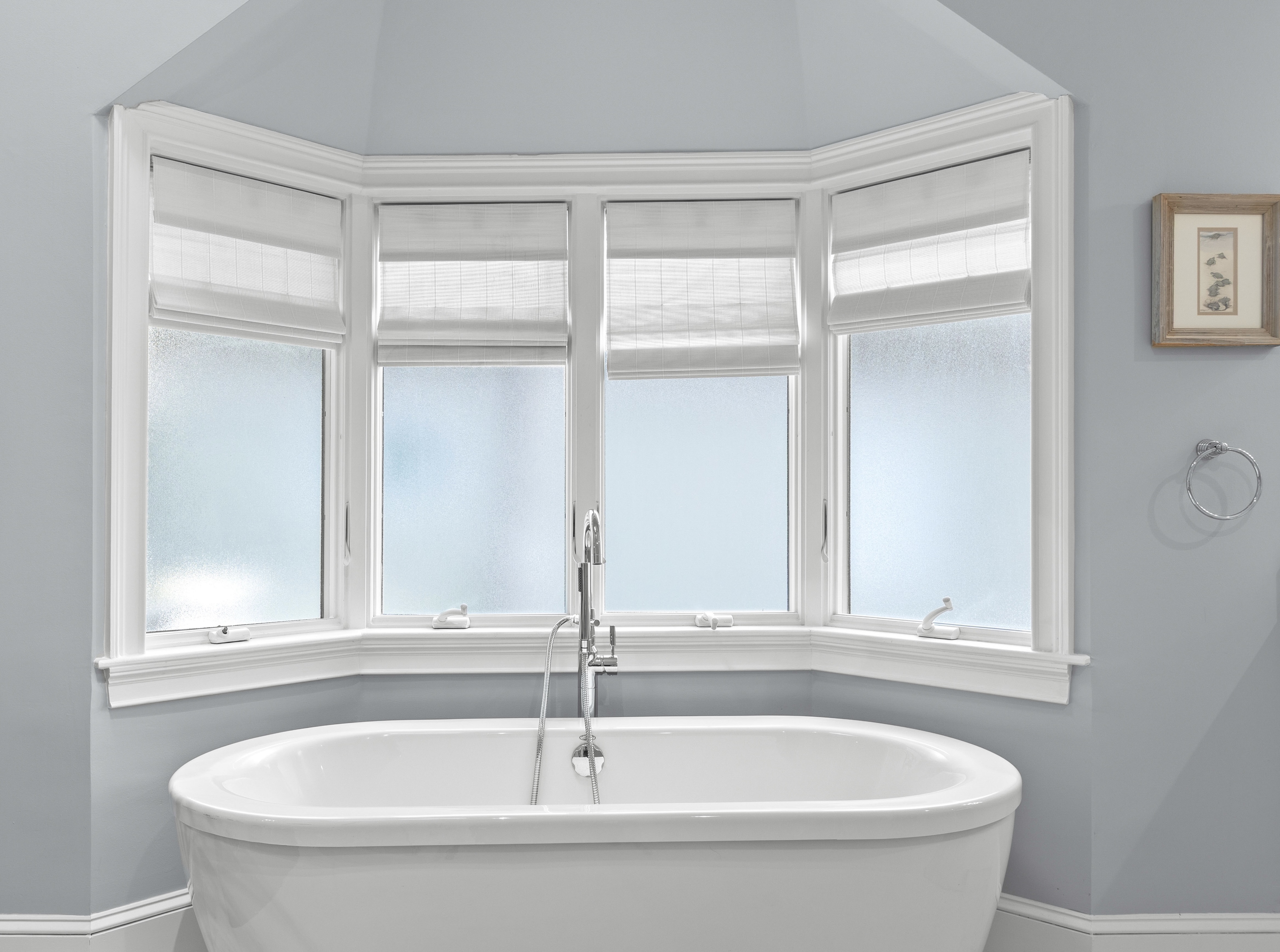 Freestanding tub under the window, with the walk-in closet off this room