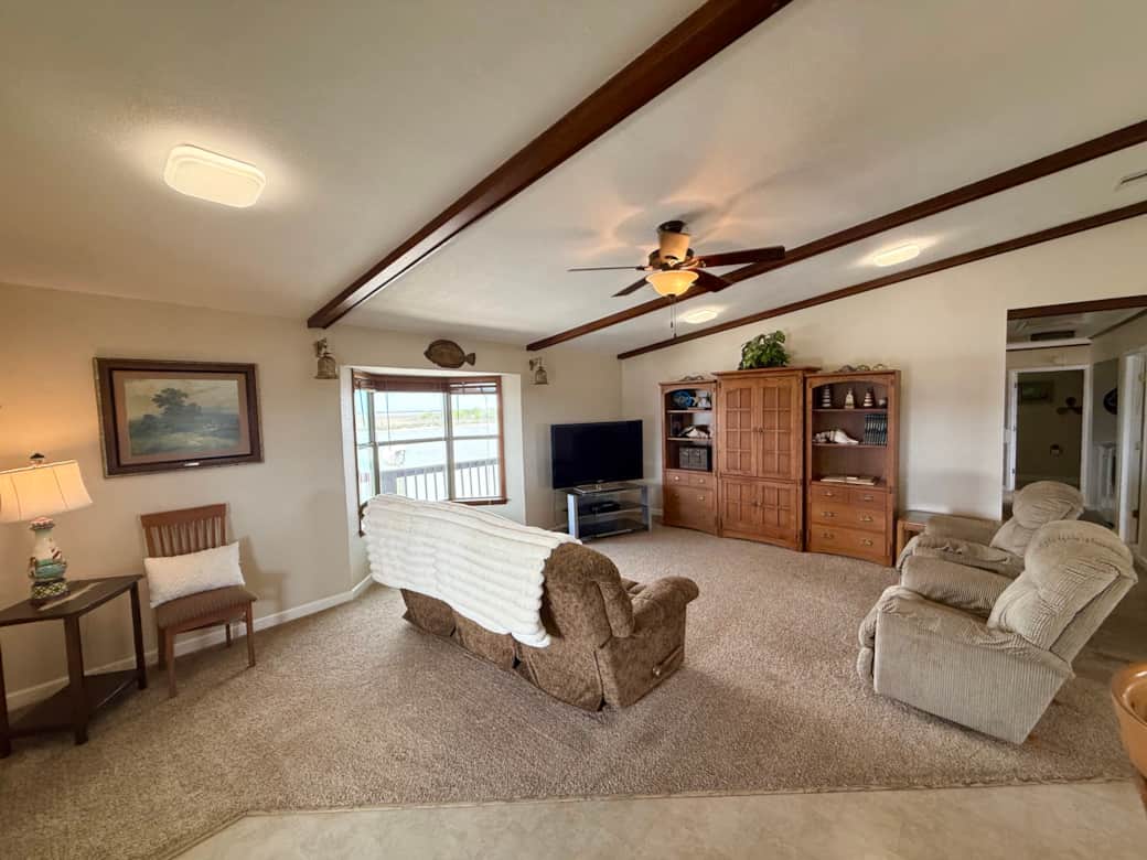 The home opens to a comfortable living area with comfortable seating and Dish TV. The home opens to a comfortable living area with comfortable seating and Dish TV.