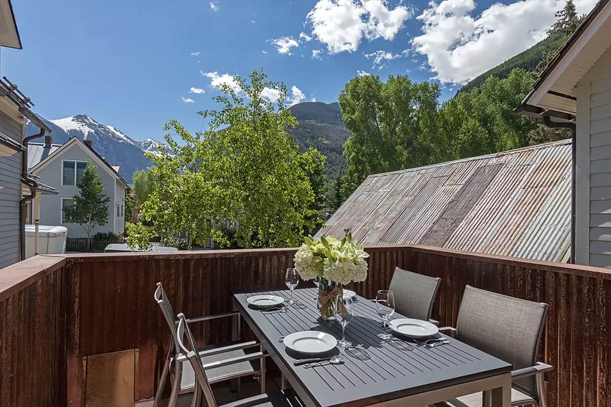 Enjoy al fresco dining on the main level deck off the living room - umbrella is available as well