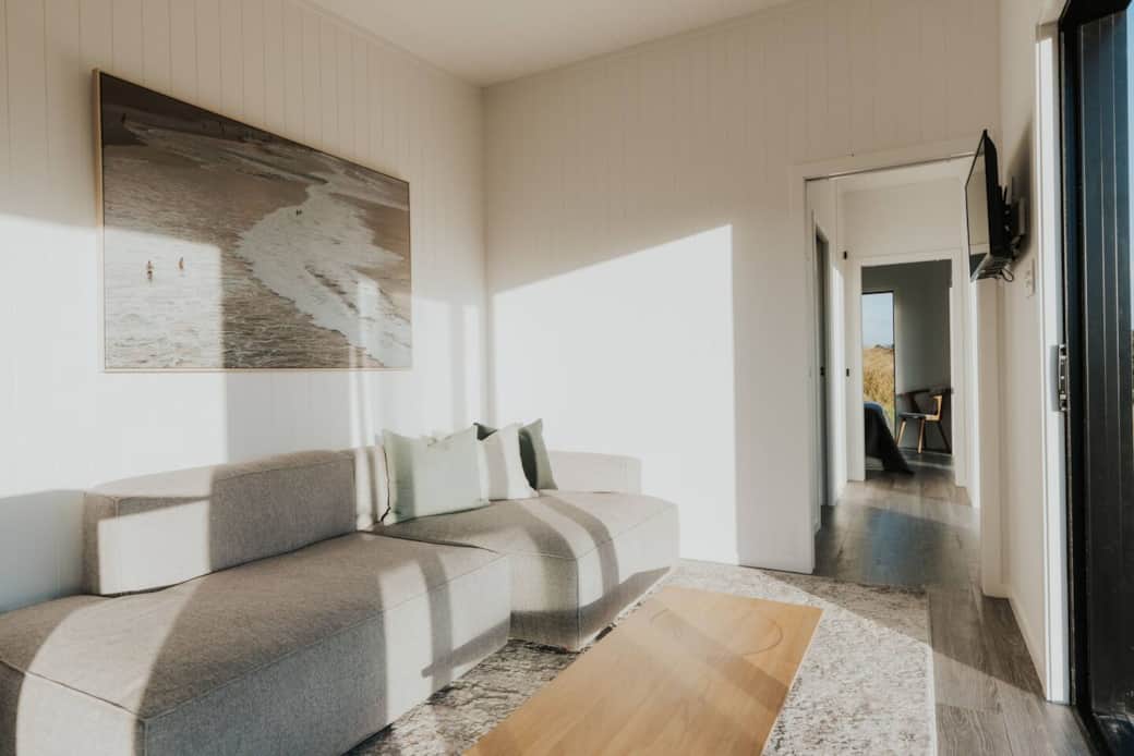 A wall of windows offers stunning views, filling the space with natural light.