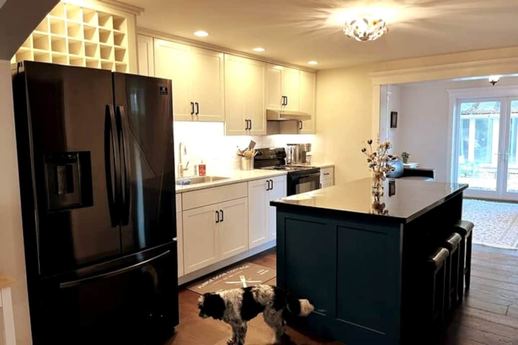 The kitchen is well-appointed and includes a custom center island with dining space, lots of countertop area, and beautiful custom cabinets. 