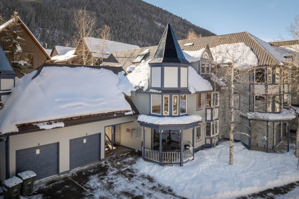 Winter exterior at Smuggler condos - the condo features a driveway parking spot