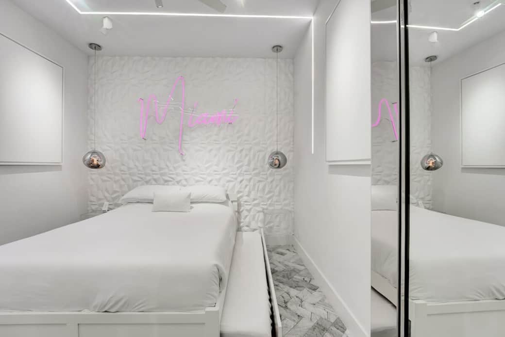 1st FLOOR: THIRD BEDROOM features 1 queen + twin XL pullout trundle bed (sleeps 3). This room also features 2 custom neon signs. Hidden sliding mirrored door separates bedroom from living room / party lounge. Connected bathroom. Kohler fixtures. 