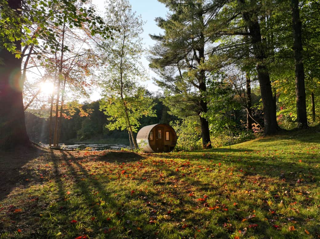 The lakeside barrel sauna is perfectly positioned to offer stunning views of the serene lake