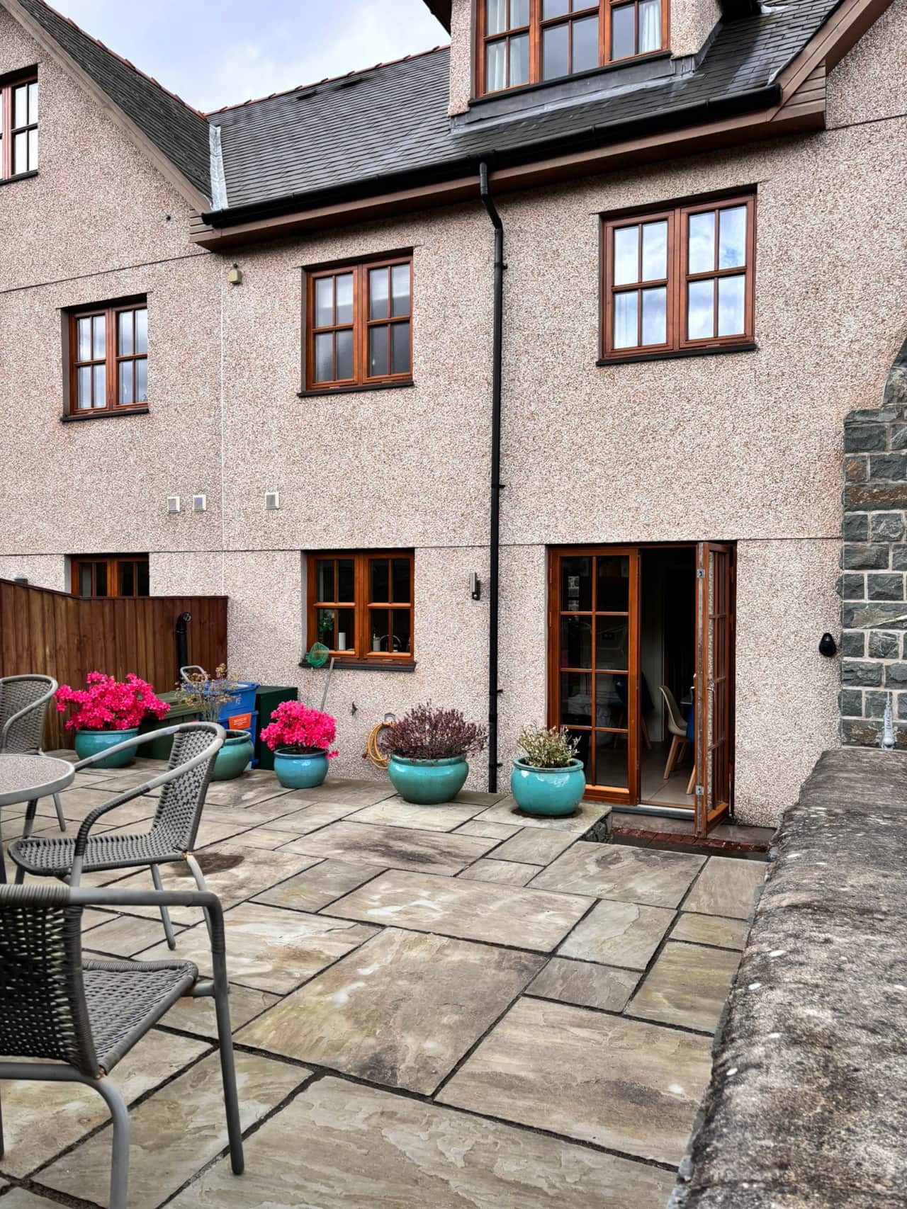 Cosy patio with vibrant planters, perfect for relaxation.