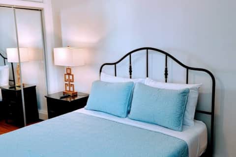 The Fulton — sunlit living room, furnished short-term rental near Bed-Stuy & Williamsburg with quick Manhattan access